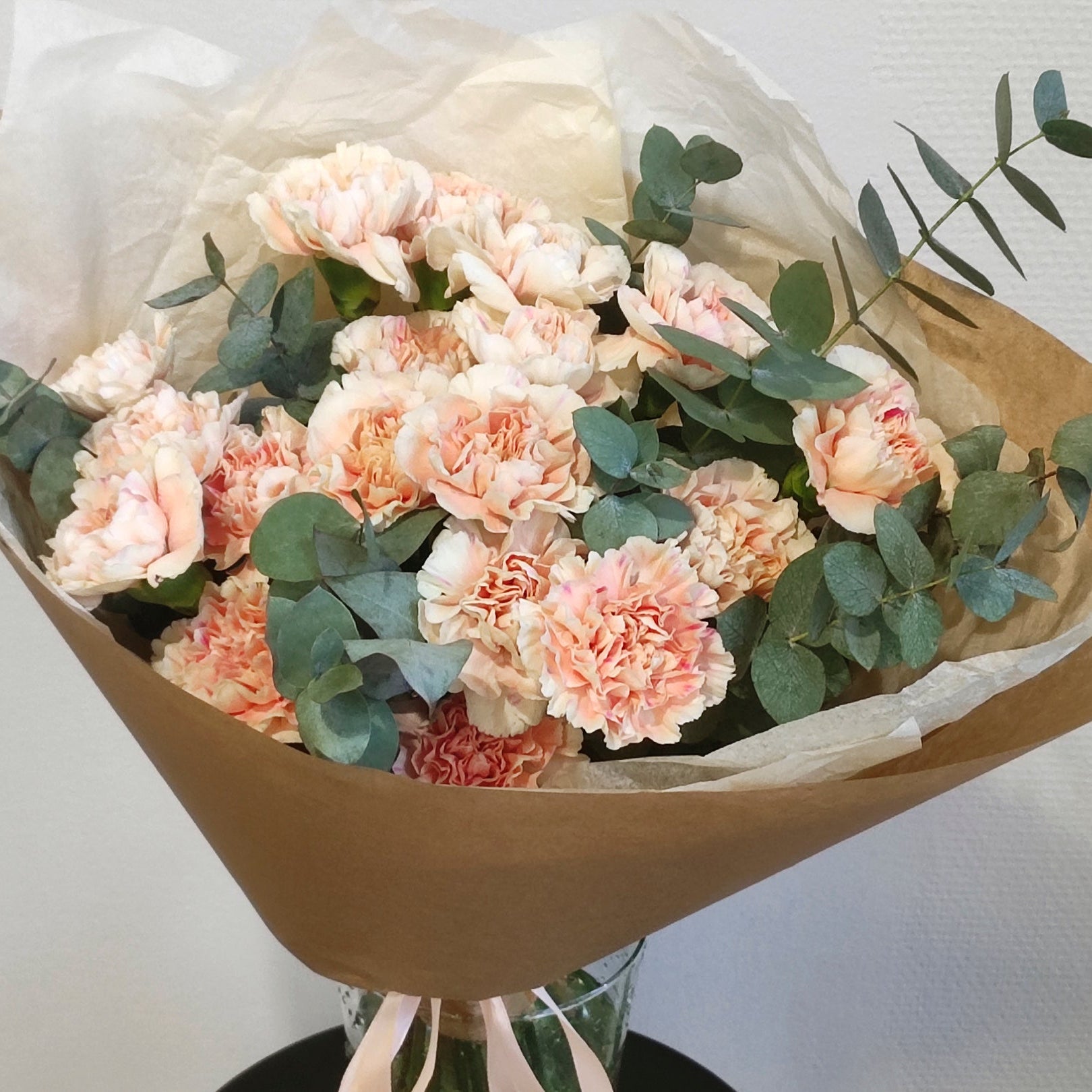 Delicate bouquet of cream dianthus and eucalyptus.