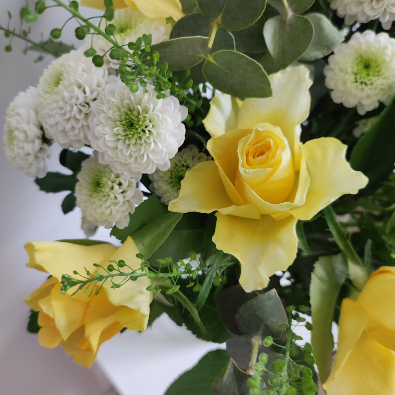 Delicate sunny bouquet with yellow roses.