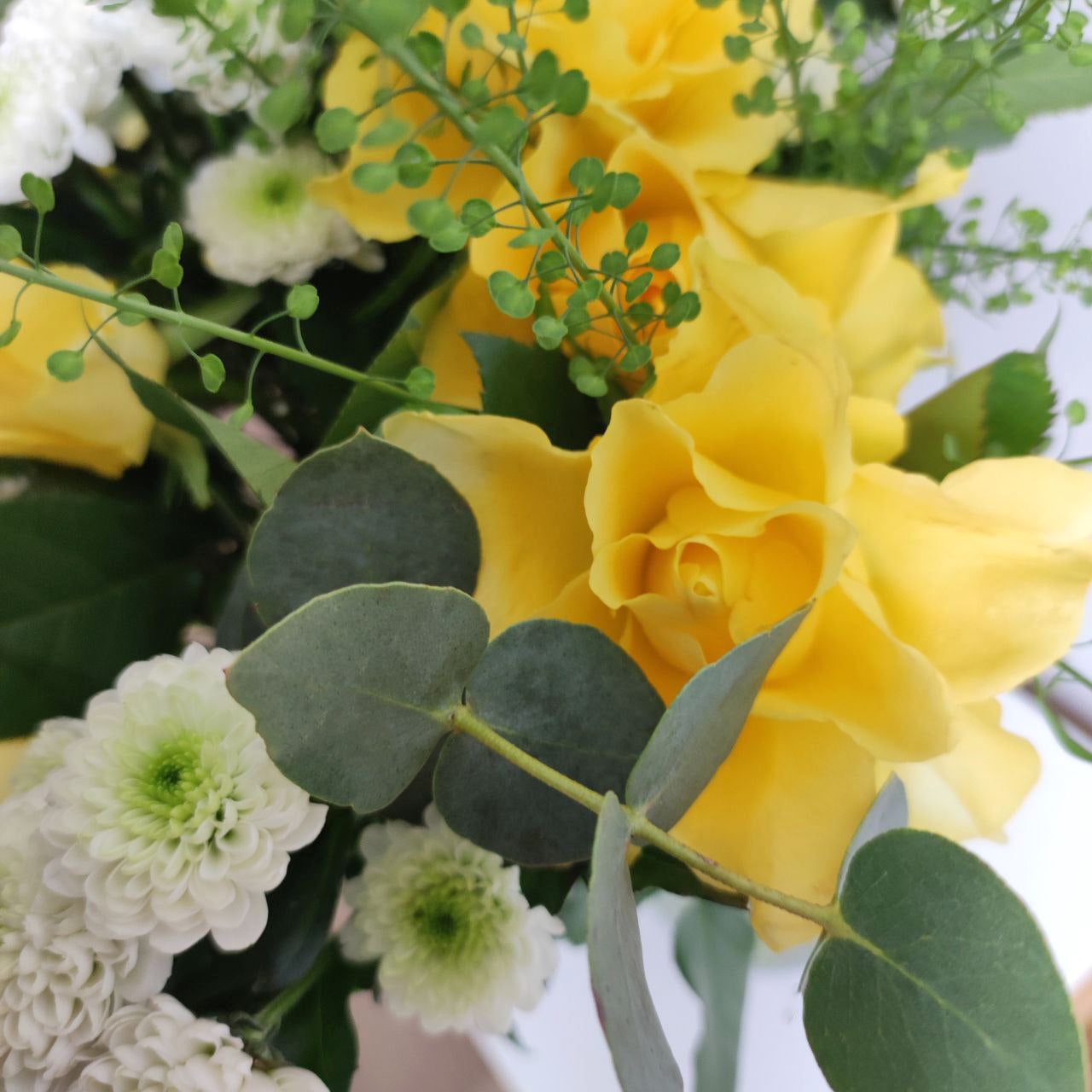 Delicate sunny bouquet with yellow roses.