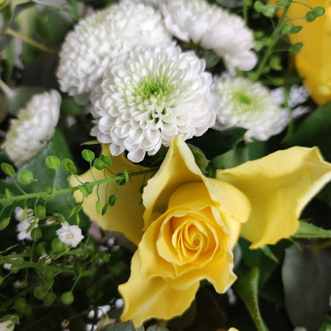 Delicate sunny bouquet with yellow roses.