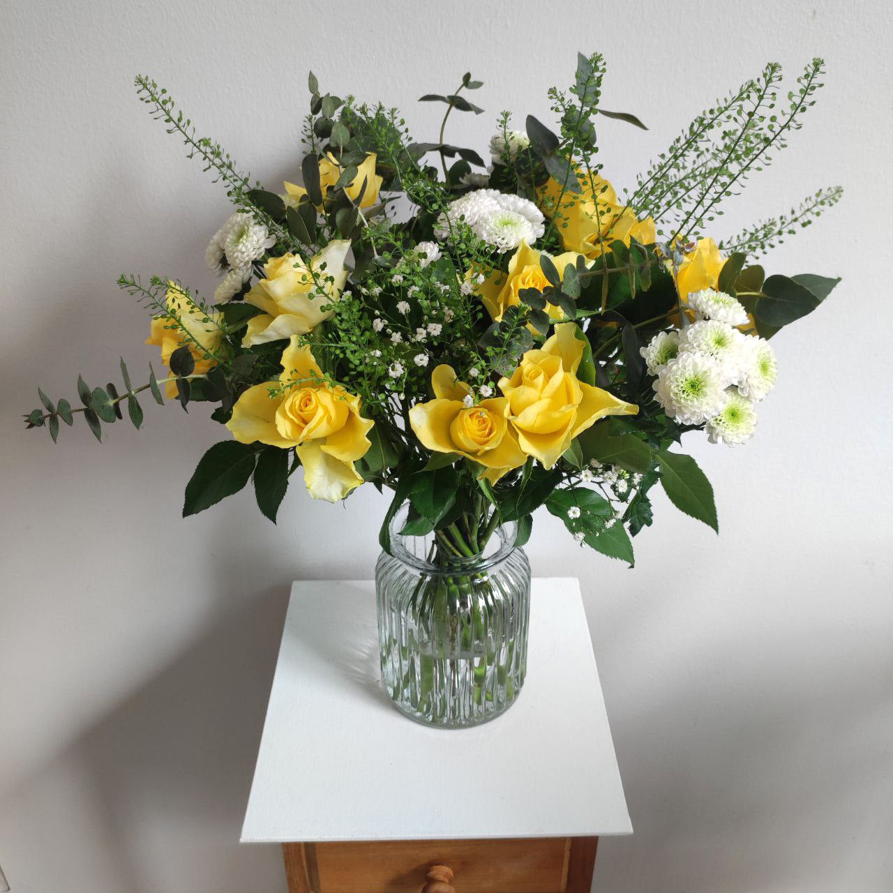 Delicate sunny bouquet with yellow roses.