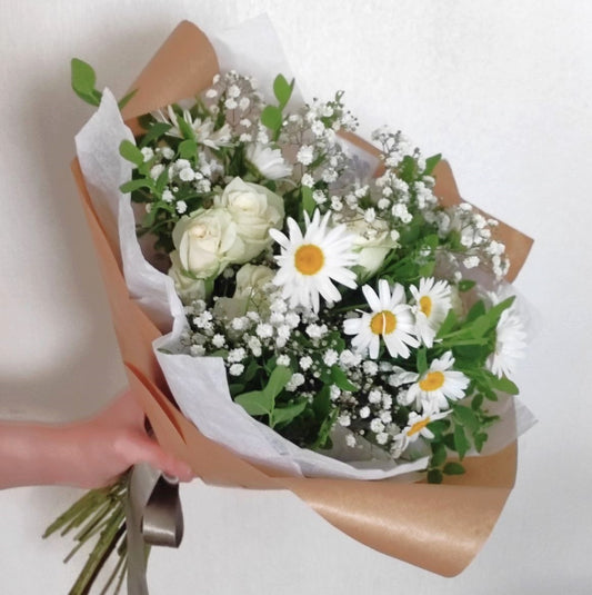 Summer bouquet with daisies and white roses in cottagecore style