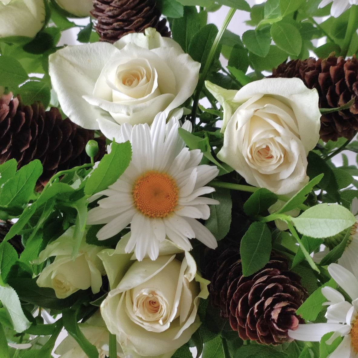 Summer forest bouquet with daisies, white mini roses and cones