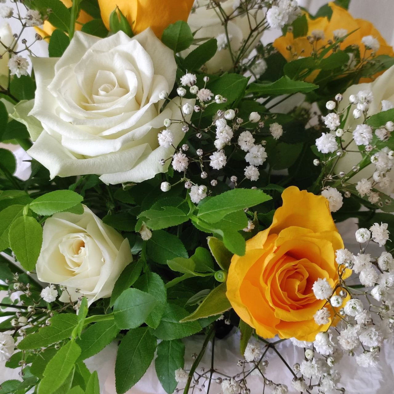 Composition with yellow roses in a box